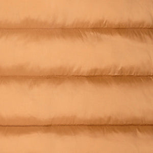 A person stands facing away in the SAVE THE DUCK - ELSIE PUFFER JACKET by SAVE THE DUCK, paired with loose green pants and tan boots against a plain light background.