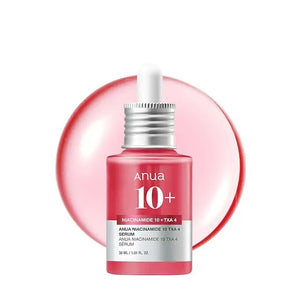 A pink dropper bottle of GLOWISS ANUA 10+ NIACINAMIDE SERUM 30ML is displayed before a glossy pink droplet, emphasizing this niacinamide and tranexamic acid serum on a clean white background.