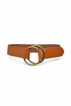 The ADA - JOSIE BELT by ADA is a brown leather belt featuring two overlapping brass rings as the buckle, displayed flat on a white background.