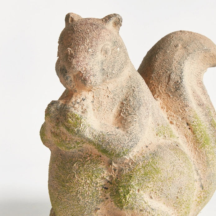 The NAPA HOME AND GARDEN - WEATHERED GARDEN SQUIRREL adds charm to your decor with its weathered look, bushy tail, and detailed design, perfect for placing beside curated furniture indoors or outdoors.