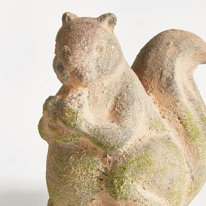 The NAPA HOME AND GARDEN - WEATHERED GARDEN SQUIRREL adds charm to your decor with its weathered look, bushy tail, and detailed design, perfect for placing beside curated furniture indoors or outdoors.