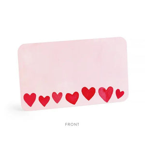The E. FRANCES - LITTLE NOTES BLUSH MINI HEARTS is a rectangular mini note card with a light pink background and red hearts in various sizes. "Little Notes® by E. FRANCES PAPER" and "Please recycle me." are printed at the bottom.