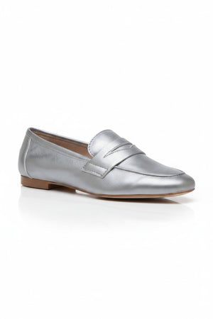 The MICHELE LOPRIORE - PAOLA LOAFER is a black genuine leather loafer with a low heel, almond toe, and simple stitched design, shown in profile against a light textured background.