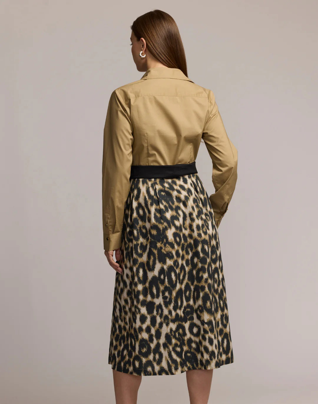 A woman wears the HINSON WU Robin Long Sleeve Combo Dress in animal print, featuring a tan button-up top and high-waisted leopard skirt with a black belt, set against a plain light background.
