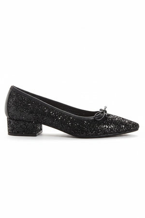 A single REQINS - FETICHE GLITTER HEELED BALLERINA shoe, black and covered in glitter, viewed from above with a small bow on the toe and "REQINS" on the insole—perfect elegant party shoes.