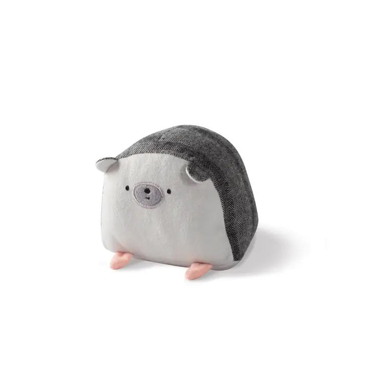 The PET SHOP BY FRINGE STUDIO - HEDGEHOG BALL DOG TOY is displayed against a white background. This adorable flannel toy features a round, plush body with a gray front and dark gray back, a cute face adorned with a small smile and black eyes, tiny pink feet, and intricate embroidered designs that enhance its charm.