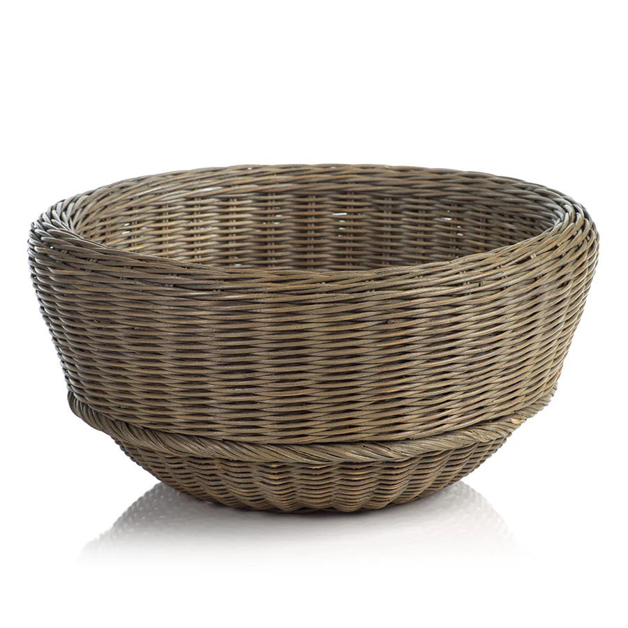 The MONTEVERDE RATTAN BOWL by ZODAX, a round and shallow natural brown wicker basket measuring 46.99 cm x 22.86 cm (18.5 in x 9 in), is displayed on a white surface.