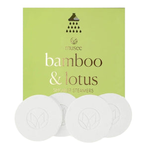 A green box labeled “MUSEE - BAMBOO & LOTUS SHOWER STEAMERS” is displayed, featuring four white round steamers embossed with a leaf design in front. The brand name “MUSEE” appears above the product name, highlighting these natural shower steamers crafted to deliver a spa-like experience.