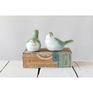 Add a charming touch to your home décor with the STONEWARE BIRD set from CREATIVE COOP—two small figurines in green and white reactive glaze, one upright and one leaning, perfect as stylish accents.