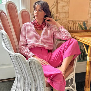 The FAIRCHILD BALDWIN - THE BELLA NECKLACE showcases layered strands of iridescent green Italian resin beads with a faceted design for a shimmering effect, finished with a smooth light green clasp that complements its vibrant hues.