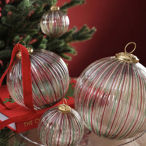 RIBBED MULTI RED AND GREEN GLASS ORNAMENT: a 4-inch ribbed glass ball featuring vertical red, green, and gold stripes with a gold cap.