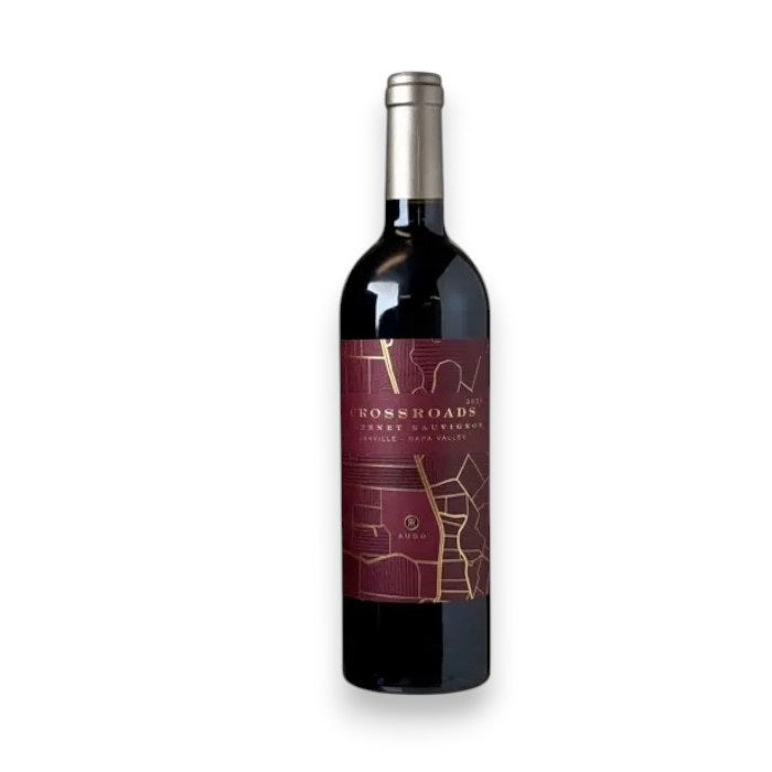 A bottle of WINE: GRAPEVINE RUDD OAKVILLE ESTATE CROSSROADS 2021 Cabernet Sauvignon, upright on a white background with a maroon and gold geometric label—offering vibrant red currant and black cherry notes in every pour.