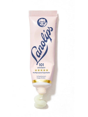 A pink tube labeled “LANOLIPS - 101 OINTMENT MULTIPURPOSE SUPERBALM” from LANOLIPS—an ultra-hydrating moisturizer—displays a blue logo with a sheep’s head and five gold stars, standing upright on a white background.
