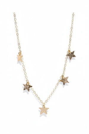 The KENDA KIST - THE 5 STAR CHOCKER NECKLACE is a delicate 14k gold filled choker featuring dainty stars along an elegant chain, designed by KENDA KIST.