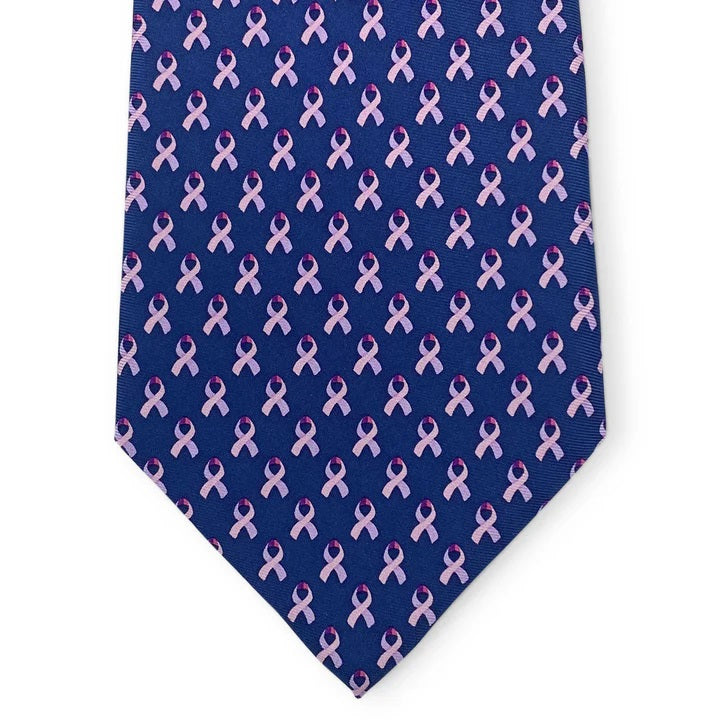 The BIRD DOG BAY - CARE FOR A CURE™ Silk Tie in Navy features a repeating pattern of small pink awareness ribbons, symbolizing breast cancer awareness.