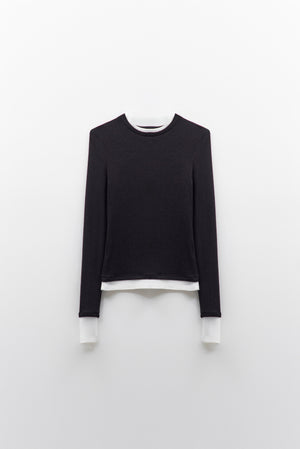 The ELEH - THE CONTRAST LAYER TOP by ELEH is a modern black long-sleeved sweater with white trim on the collar, cuffs, and hem—an effortlessly versatile wardrobe essential shown flat against a white background.
