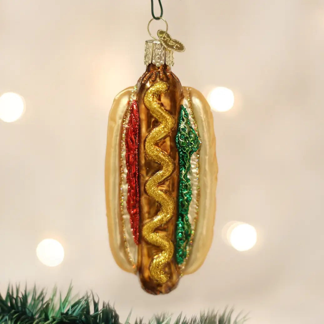 Old World Christmas HOT DOG ORNAMENT shaped like a hot dog with a yellow mustard swirl, red ketchup, and green relish.