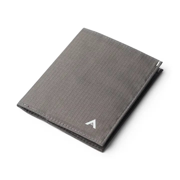 The ALLETT Original Wallet in RFID-blocking charcoal grey nylon features a minimalist design with a grid pattern and small white triangular logo, shown closed against a white background.
