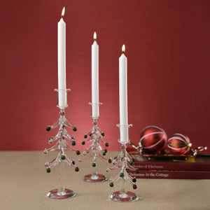 ZODAX HOLIDAY TREE GLASS TAPER CANDLE HOLDER 8.25″ made of clear borosilicate glass in the shape of a Christmas tree with small red and green glass ornaments.