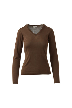 A woman with dark hair pulled back smiles in a KINROSS CASHMERE Fitted Vee Neck Silk Cashmere Sweater in blue and black pants, standing against a plain white background.