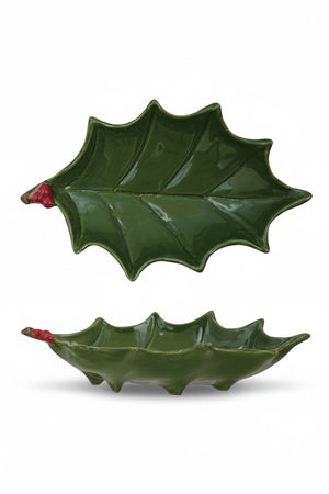 Top and side views of a Creative Coop HAND PAINTED HOLLY LEAF SHAPED FOOTED TRAY WITH BERRIES, showing its holly leaf shape, hand-painted red berries, and short feet.