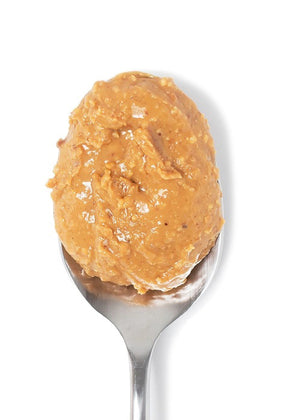 A jar of BIG SPOON ROASTERS Pecan Peanut Wildflower Honey Nut Butter with a gold lid. The label shows it contains wildflower honey, organic coconut oil, and sea salt. The jar is 13 oz or 369 g and is described as handcrafted nut butter from BIG SPOON ROASTERS.