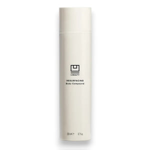 A tall, white bottle with a minimalist design and black text displays "U BEAUTY RESURFACING BODY COMPOUND 200ML." This body exfoliant is formulated to improve skin texture for a smoother look.
