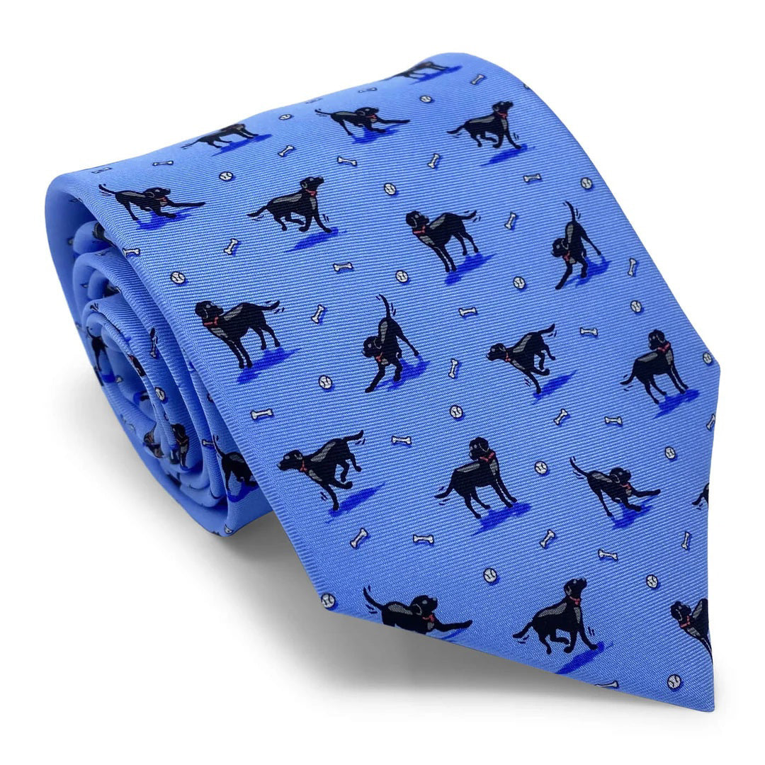 The BIRD DOG BAY - BLACK LAB TIE by BIRD DOG BAY is a blue necktie handmade in New York, featuring black Labrador dogs, white bones, and small white balls.
