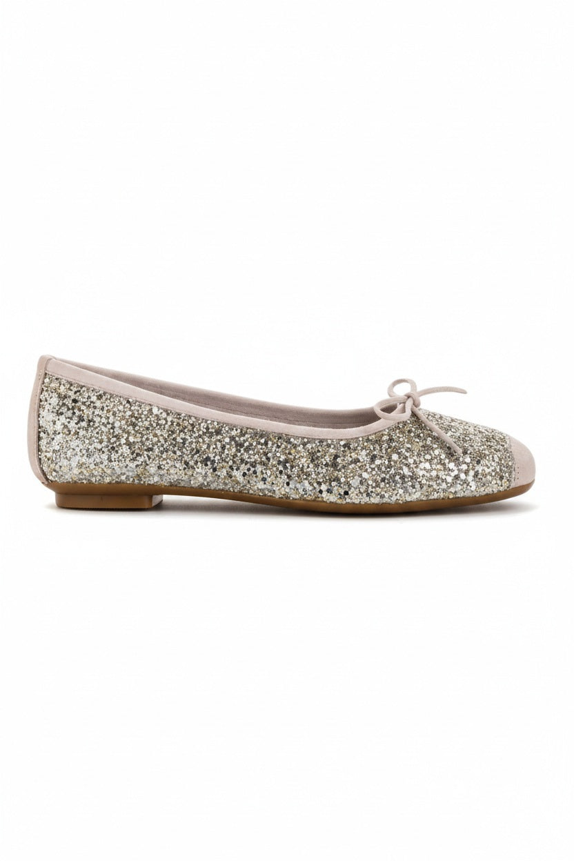 The REQINS HARMONY Sequin Ballerina Flat in Ice features a sparkling design with subtle pink trim and a small bow on the toe, shown from above against a plain light background.