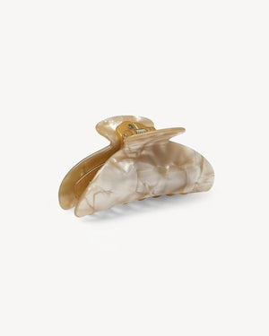 The MACHETE - MIDI HEIRLOOM CLAW by MACHETE is featured against a plain white background. This cream-colored hair accessory is crafted from luxurious Italian acetate and features curved edges with interlocking teeth, making it ideal for securing medium hair with effortless style.