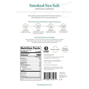 A package of PURELY SPROUTED - SMOKED SEA SALT SPROUTED ALMONDS from the PURELY SPROUTED brand is displayed. The front of the pack highlights key features such as being nutrient-dense, plant-based protein, gluten-free, a superfood, and vegan. The packaging shows smoked sea salt almonds along with nutrition information.