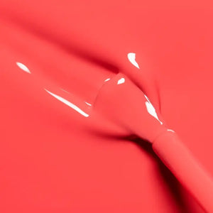 A bottle of MANUCURIST INC’s GREEN™ Nail Polish in the shade “Pulp,” showcasing a vibrant coral hue, with a sleek black cap and a label that reads “green quick dry intense color,” made using bio-sourced ingredients.