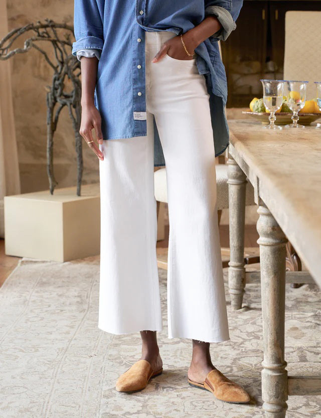 A pair of white high-waisted wide-leg Galway Gaucho jeans by FRANK &amp; EILEEN, featuring front and back pockets, belt loops, and a button and zipper closure. The FRANK AND EILEEN - GALWAY GAUCHO JEAN IN WHITE is displayed flat against a textured light background.