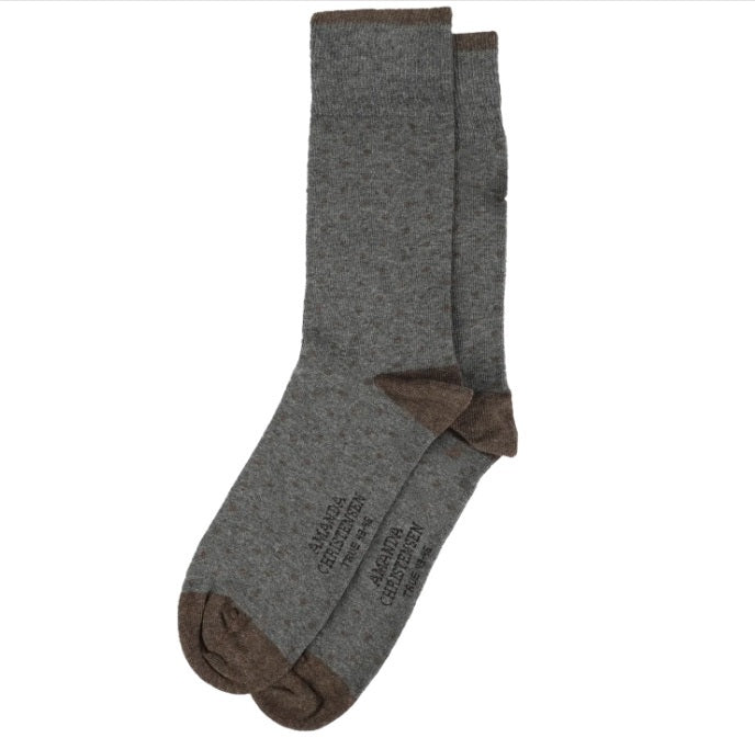 A pair of AMANDA CHRISTENSEN - TRUE DOT MID-CALF SOCKS IN GREY MELANGE, featuring contrasting brown heels, toes, and cuffs, crafted from a combed cotton blend and displayed flat on a white background. Some text is visible on the bottom of these Italian-made AMANDA CHRISTENSEN socks.