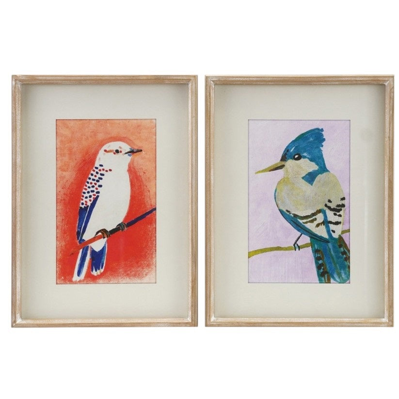 The CREATIVE COOP FRAMED WALL ART FEATURING BIRDS displays a white bird with blue and red accents on a blue branch, set against an orange-red background, in a light wood frame and white mat for rustic charm.