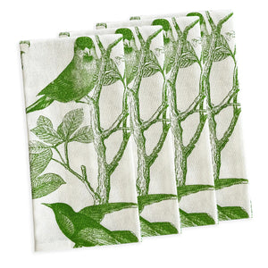 Four white cotton CASKATA - ARBOR BIRDS DINNER NAPKINS by CASKATA, made in India, are neatly stacked and display a repeating pattern of green birds on leafy branches.