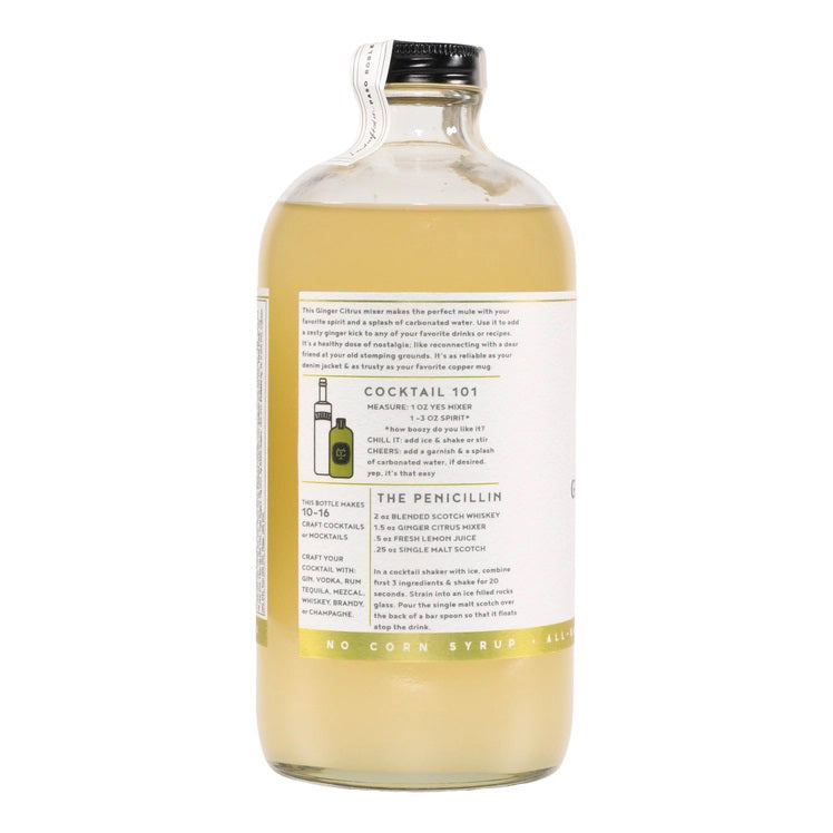 A clear glass bottle with a black cap containing Yes Cocktail Co.'s Ginger Citrus Cocktail Mixer is adorned with a white label featuring green accents. The text indicates it is crafted from fresh root, zesty lime, and has a spicy kick. The bottle holds 16 fl oz (473 ml).