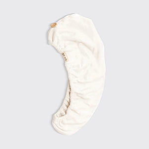 The KITSCH - QUICK DRY HAIR TOWEL, made from organic cotton and bamboo, features eco-friendly packaging with a teardrop design that promises frizz reduction for fine, curly, or straight hair. It includes an image of a person wearing the towel.