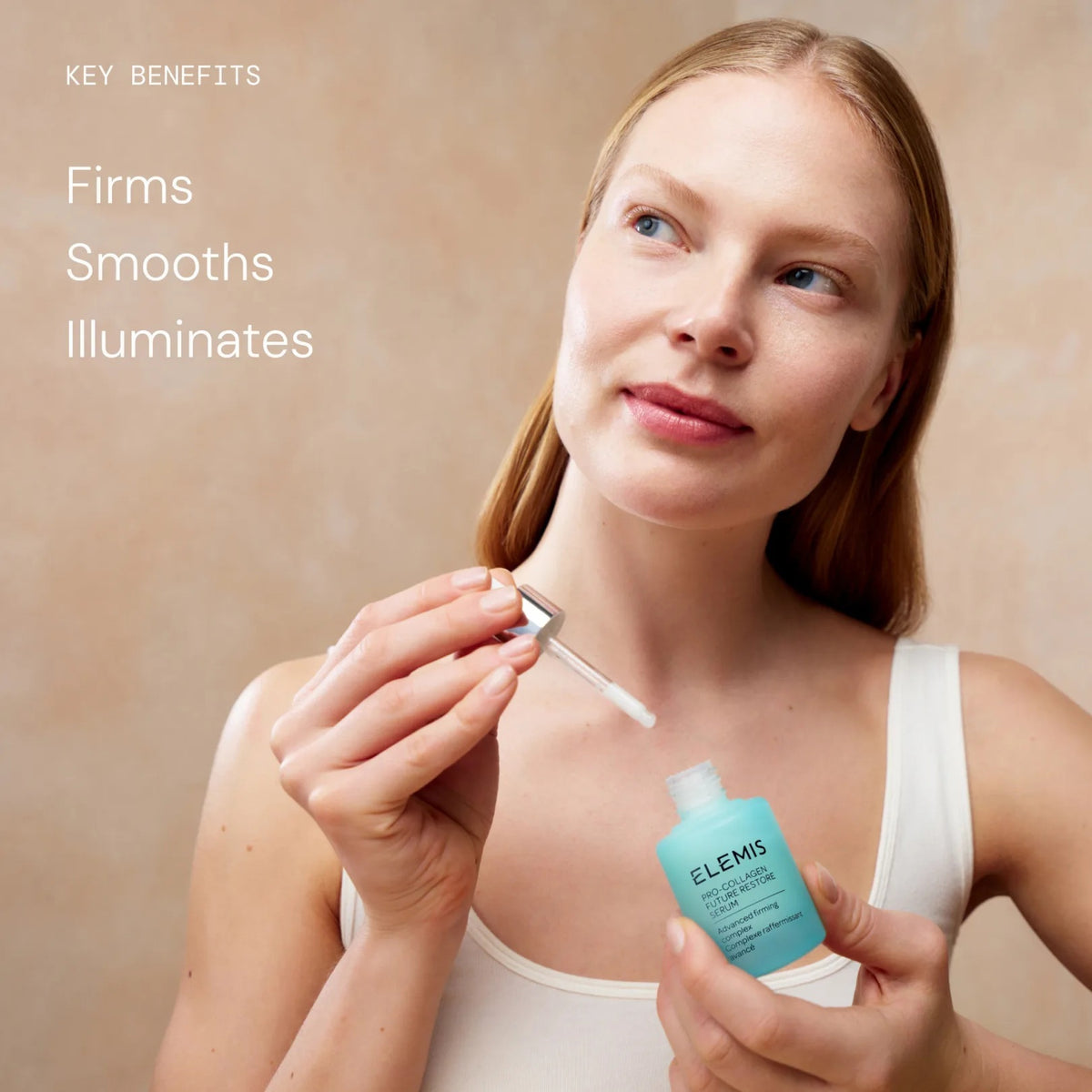 On a softly lit surface rests a bottle of ELEMIS - PRO-COLLAGEN FUTURE RESTORE SERUM by ELEMIS - STEINER, with text emphasizing its proven ability to firm skin and reduce wrinkles in just 4 days. Infused with potent marine actives and featuring the innovative opal skin algae complex, this serum represents the next generation of advanced skincare. A blurred hand is visible in the background.