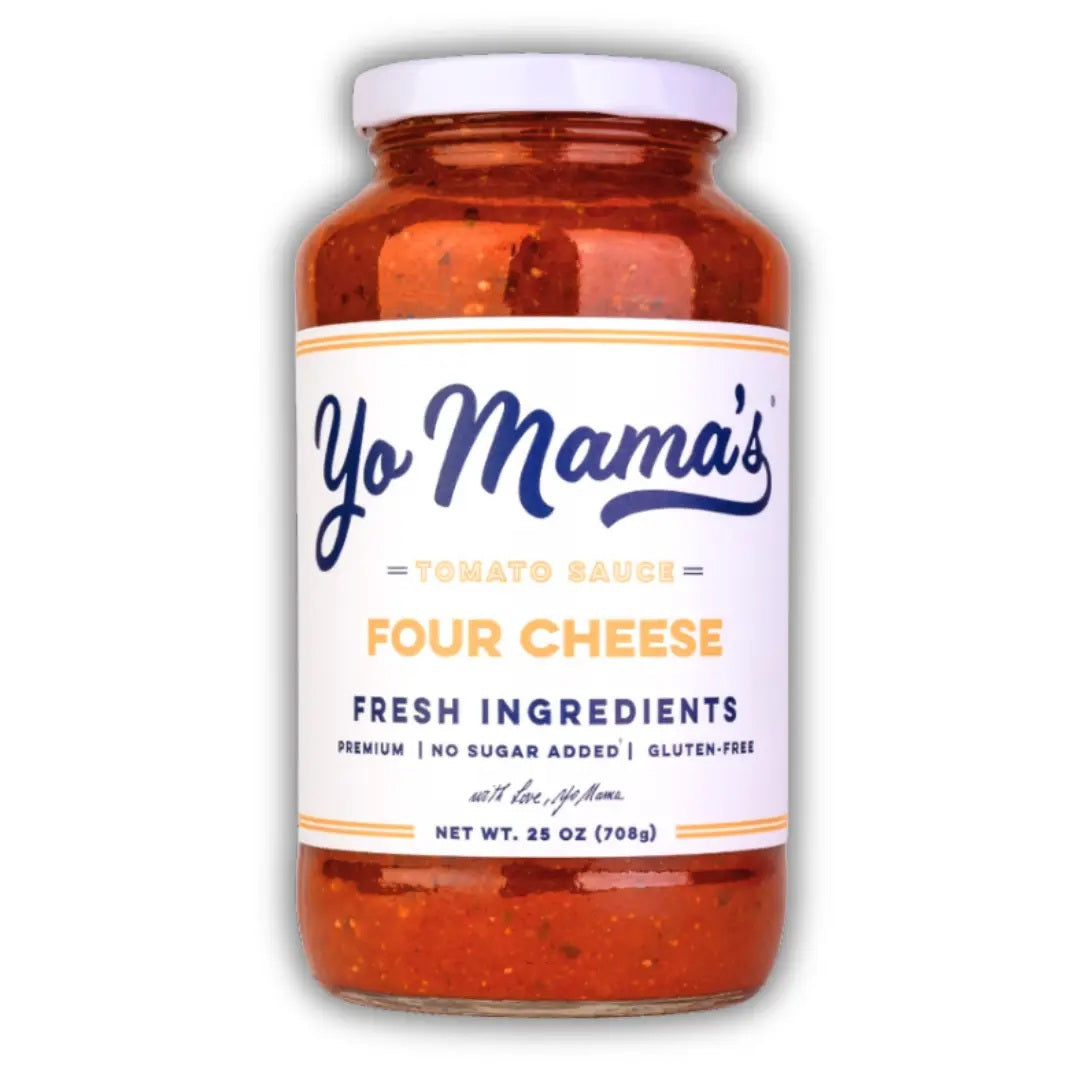 A glass jar of YO MAMA’S - FOUR CHEESE SAUCE by YO MAMA’S FOODS, featuring a white label with product details such as “fresh ingredients,” “no sugar added,” “gluten-free,” and a net weight of 25 oz (708g).