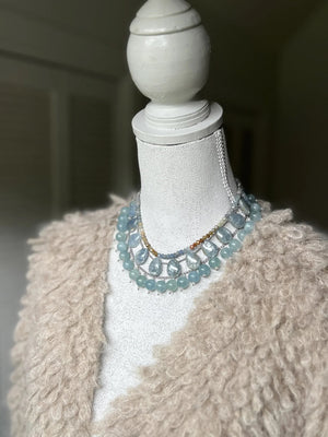 The ANN LIGHTFOOT Braided Ras du Cou Fan Calcite Necklace features large teardrop-shaped pale blue calcite stones, evenly spaced on a delicate chain with an adjustable sterling silver clasp.