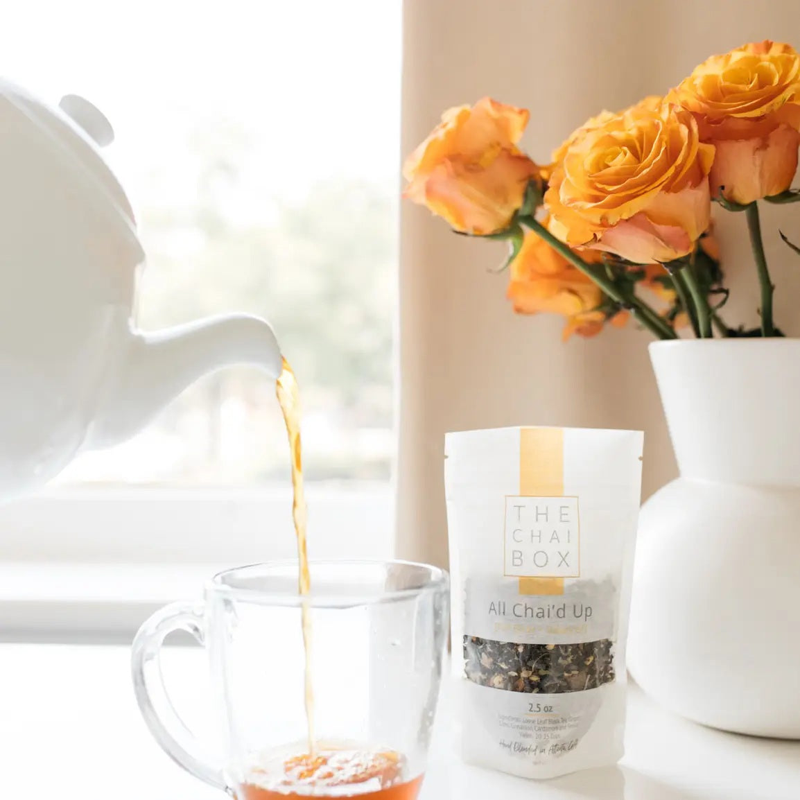 A white pouch labeled “THE CHAI BOX - ALL CHAI’D UP FULL BODY + BALANCE” from THE CHAI BOX contains a loose-leaf masala chai blend made with organic Assam black tea and yields 20–25 cups.