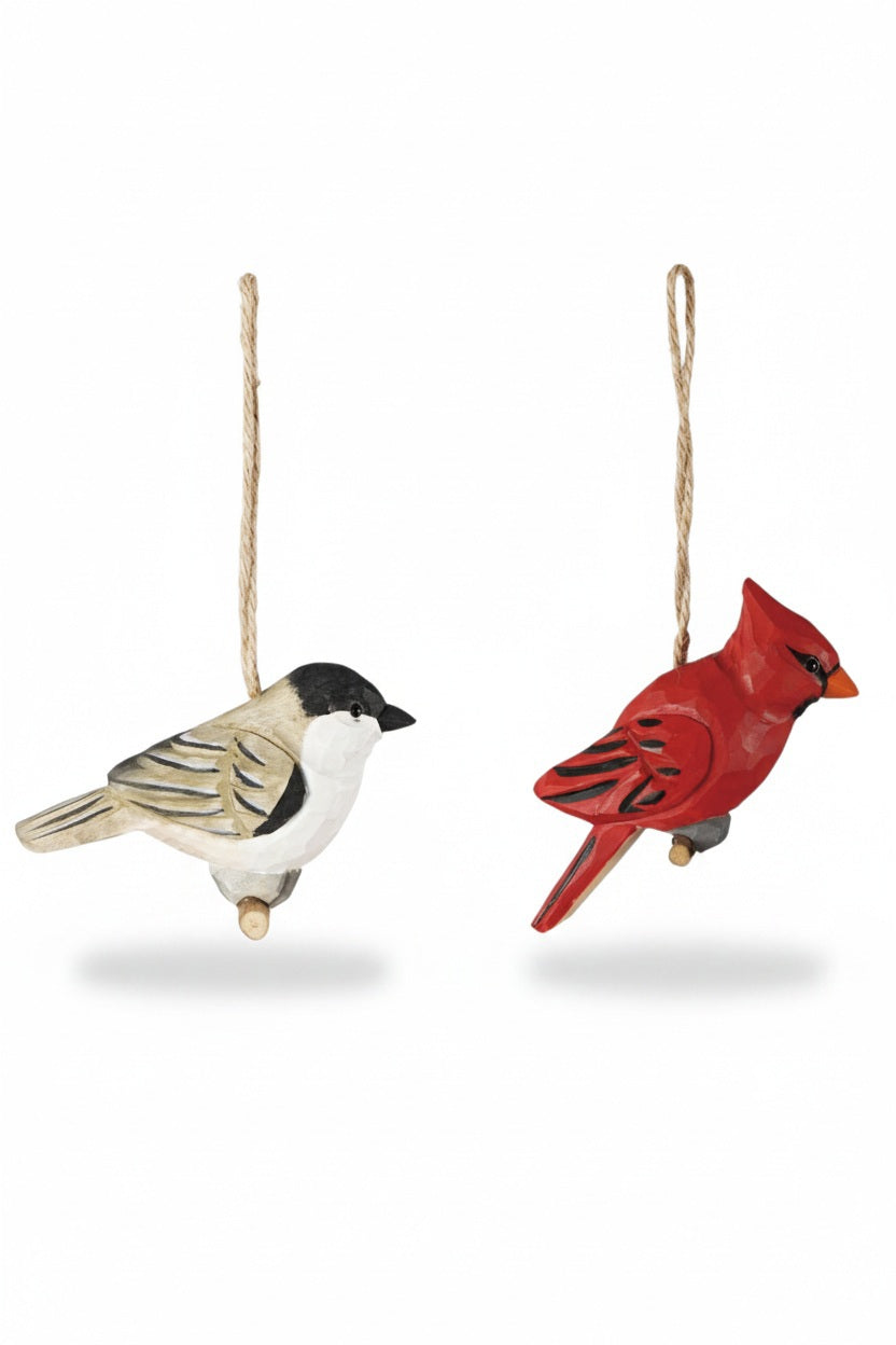 Two HAND CARVED WOOD BIRD ORNAMENT decorations, a black-capped chickadee and a red cardinal, hanging by twine loops.