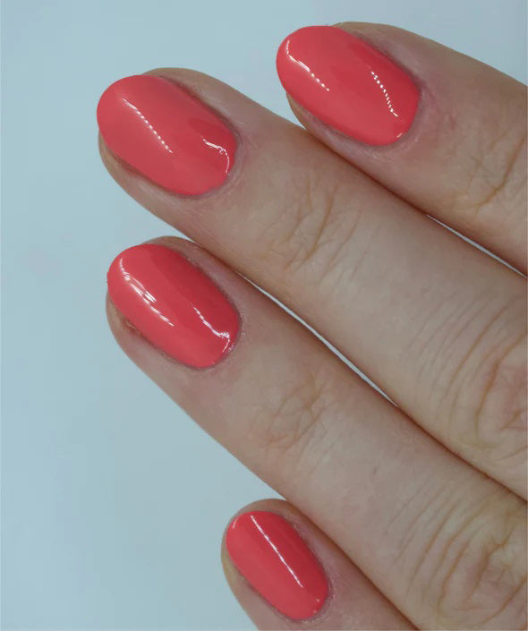 A glass bottle of TENOVERTEN - NAIL POLISH from the brand TEN OVER TEN, featuring a white cap and a dusty pink nail color. The front label displays "TEN OVER TEN" in white uppercase letters. This vegan, eight-free formula ensures both beauty and peace of mind. The background is plain and light-colored.