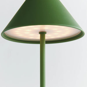 The NAPA HOME AND GARDEN - ALLUNA 10” Cordless LED Lamp in green, a compact and modern luxury table lamp featuring a metal conical shade and a round base, is displayed against a plain white background.