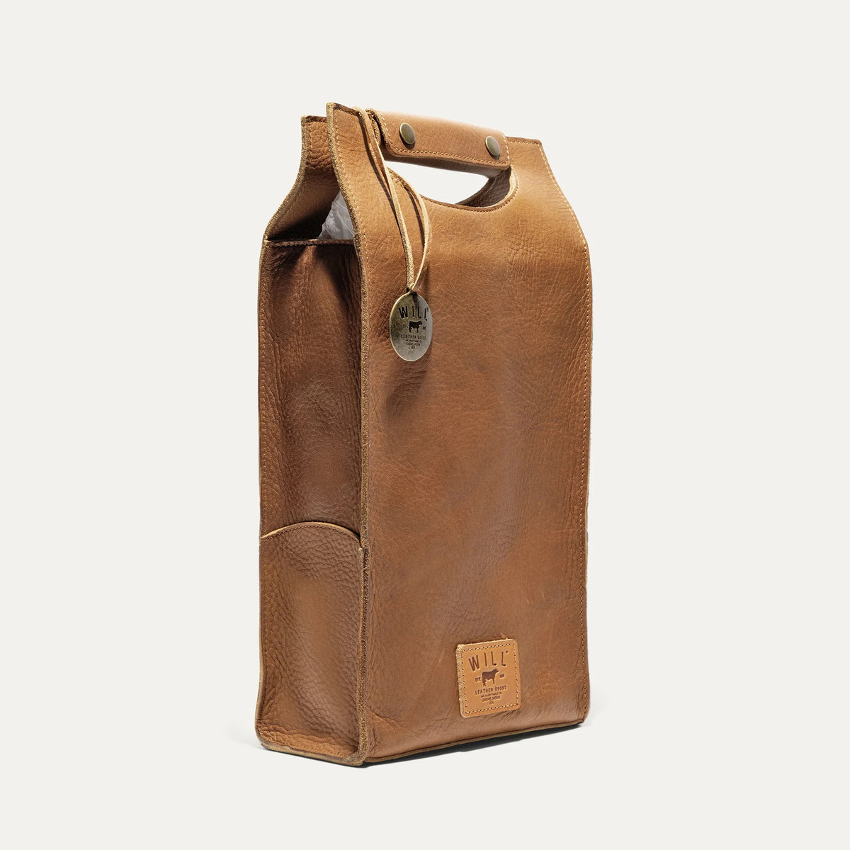 The WILL LEATHER GOODS - DOUBLE LEATHER WINE CASE is a brown full-grain leather tote featuring a top handle cutout, two metal snaps, round metal tag, and stitched "WILL" label—ideal for carrying wine in style.