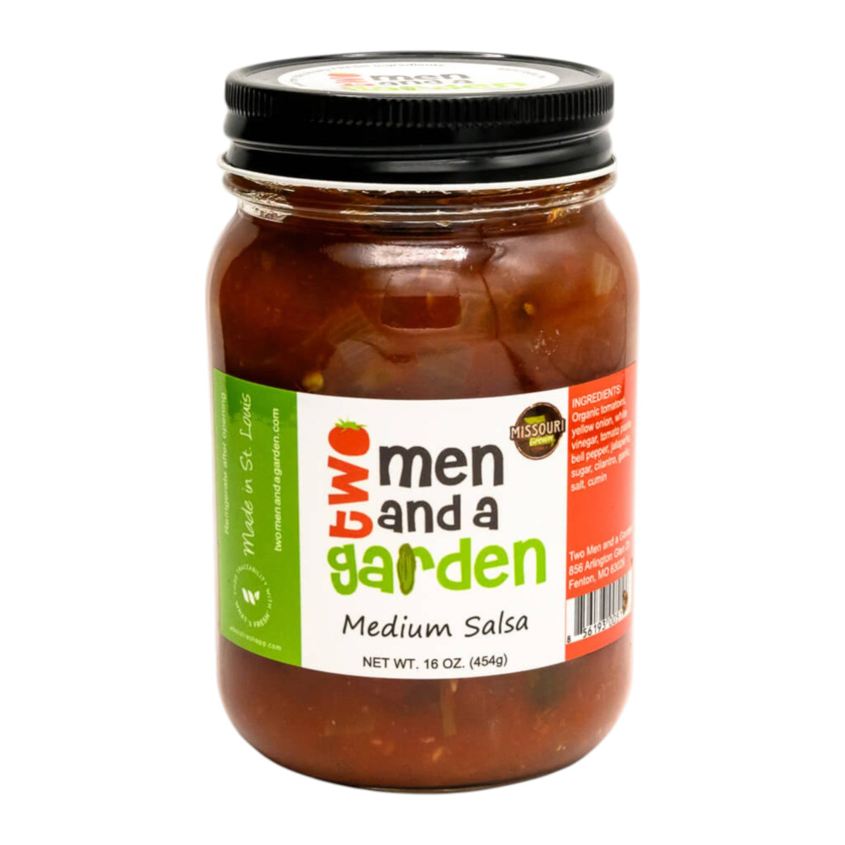 A 16oz clear glass jar of TWO MEN AND A GARDEN - MEDIUM SALSA features farm-fresh jalapeños and a white label listing ingredients and origin. This St. Louis spicy salsa comes with a black lid from the brand TWO MEN AND A GARDEN.