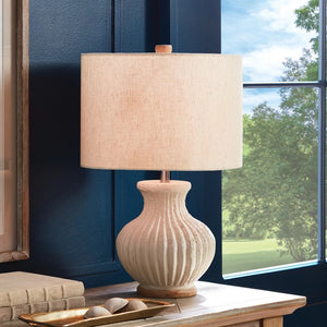 The NAPA HOME AND GARDEN - MARGOT LAMP features a textured, ribbed off-white ceramic base, round wooden bottom, beige linen drum shade, and a small wooden finial for a warm, natural touch.