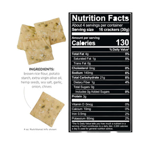 A bag of EVERY BODY EAT CHIVE & GARLIC SNACK THINS from EVERY BODY EAT is pictured alongside gluten-free crackers, garlic cloves, and chives. The black packaging features images of crackers and garlic bulbs at the top, a list of ingredients, and highlights these allergy-friendly snacks.