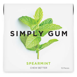 A white package of SIMPLY GUM - SPEARMINT NATURAL CHEWING GUM by SIMPLY GUM, featuring an image of fresh mint leaves. The gum, made with organic ingredients and free from aspartame, comes in a pack of 15 pieces with the text "CHEW BETTER" printed at the bottom.